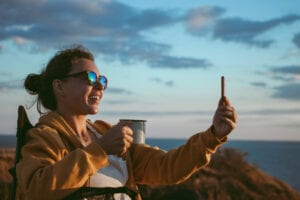 woman taking selfie on beach